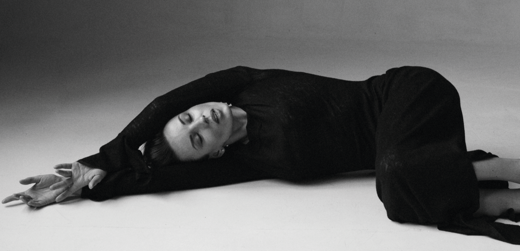 Editorial image of a woman in full black modest maxi dress | Kimesca